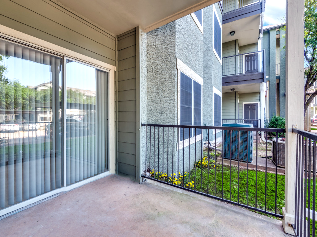 the balcony of an apartment with sliding glass doors at The Stetson