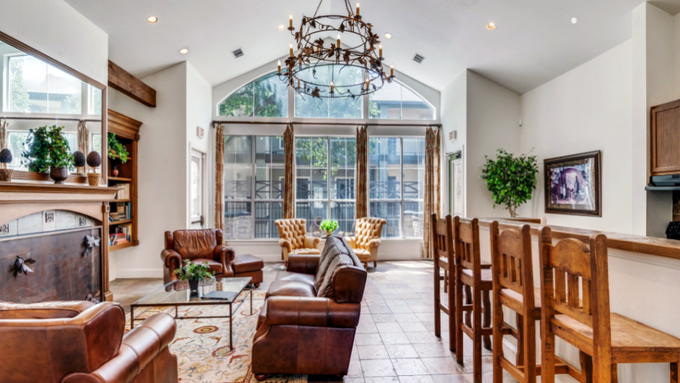 a large living room with a fireplace and a bar at The Stetson