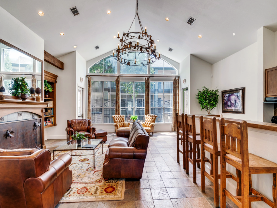 a large living room with a fireplace and a bar at The Stetson