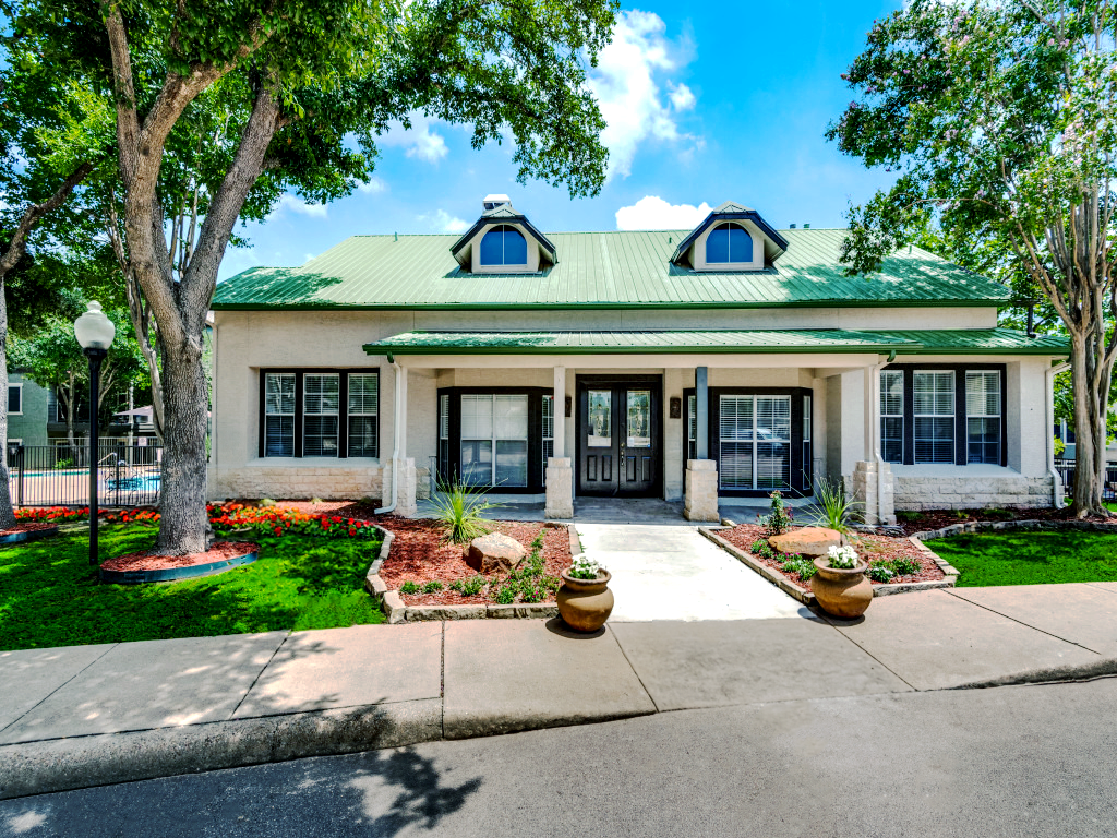 the front of a home with a green lawn and trees at The Stetson