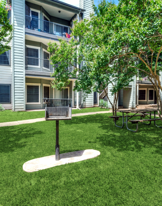 the grassy area in front of the apartment building at The Stetson